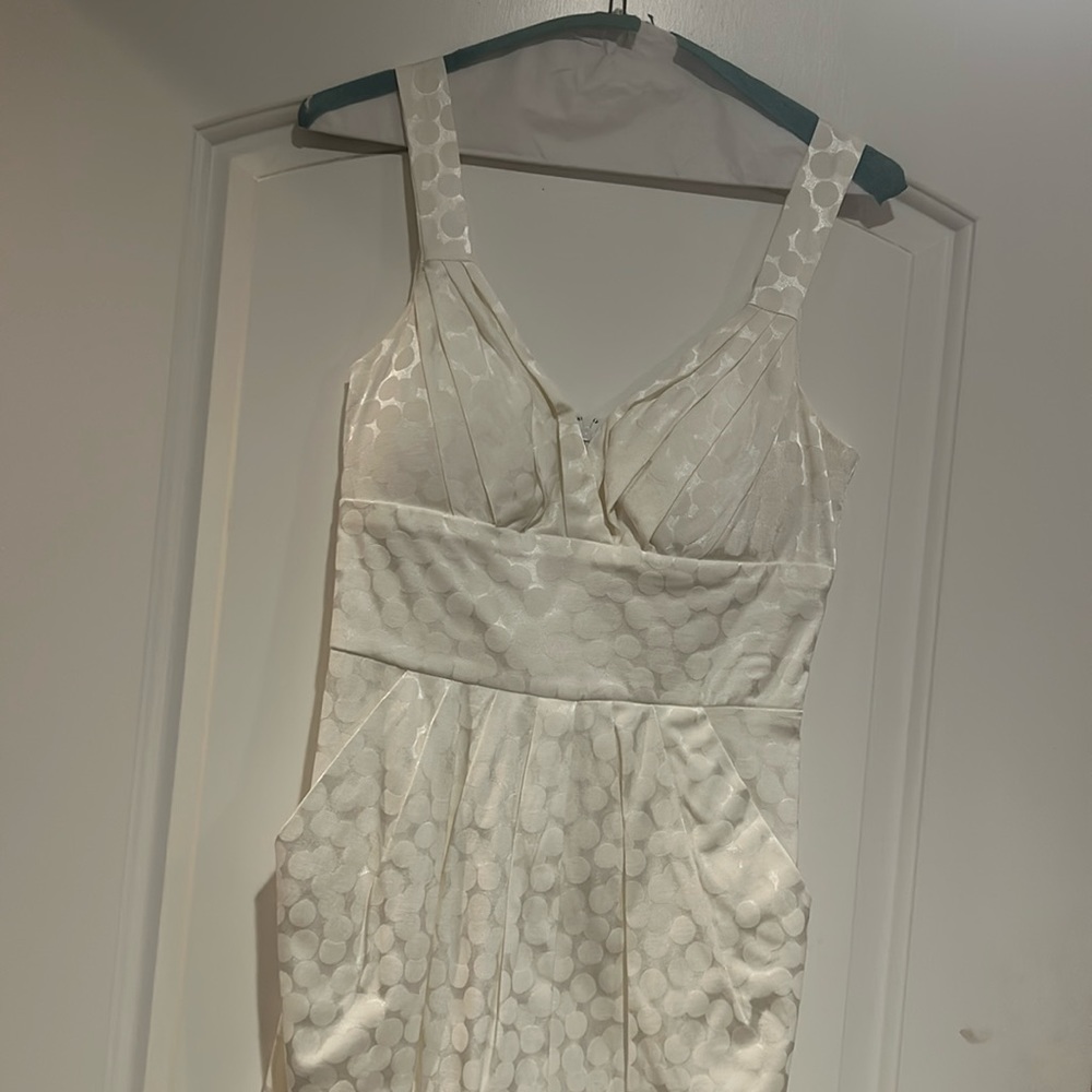 White shimmery dress with pockets.